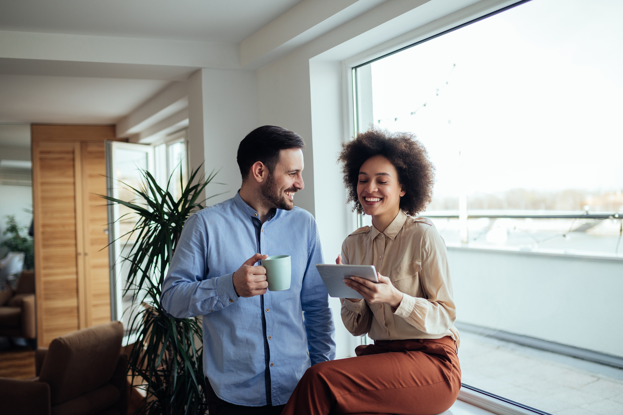 Two young business people working on a coffee break.