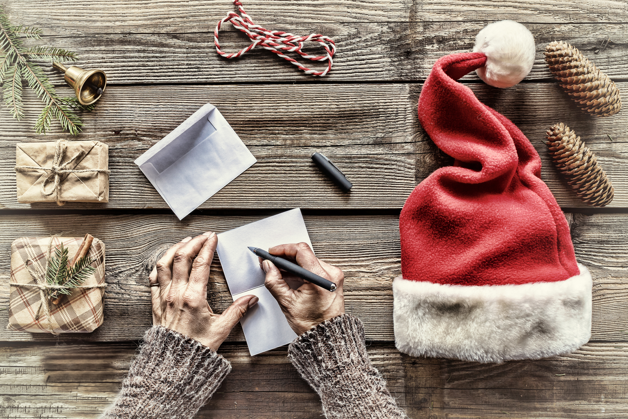 Conception: Christmas. Making Christmas gifts. A man writes a letter Greeting cards to family and friends