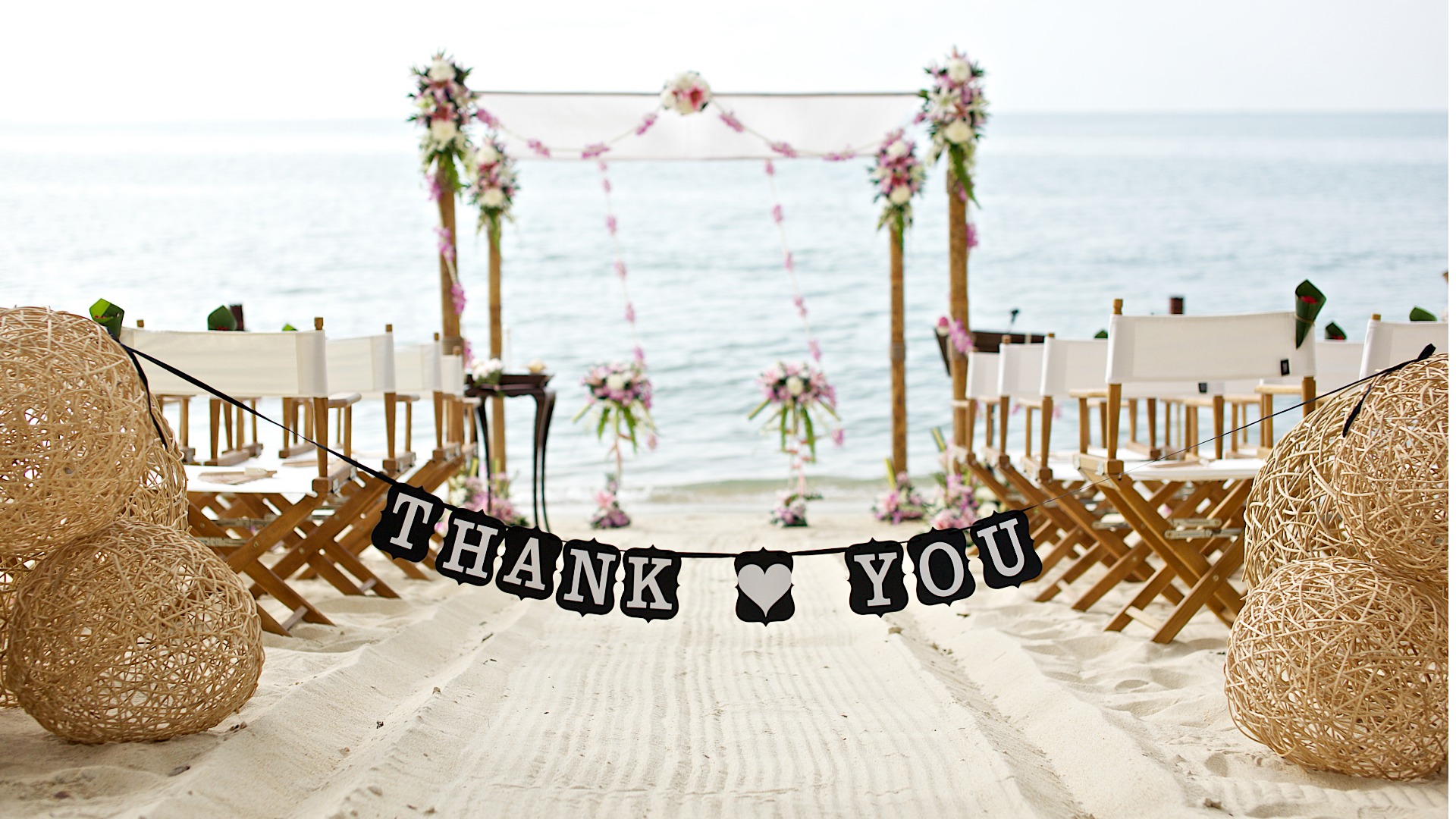 thank-you-words-banner-beautiful-beach-wedding-set-up-chairs-picture-id528727560