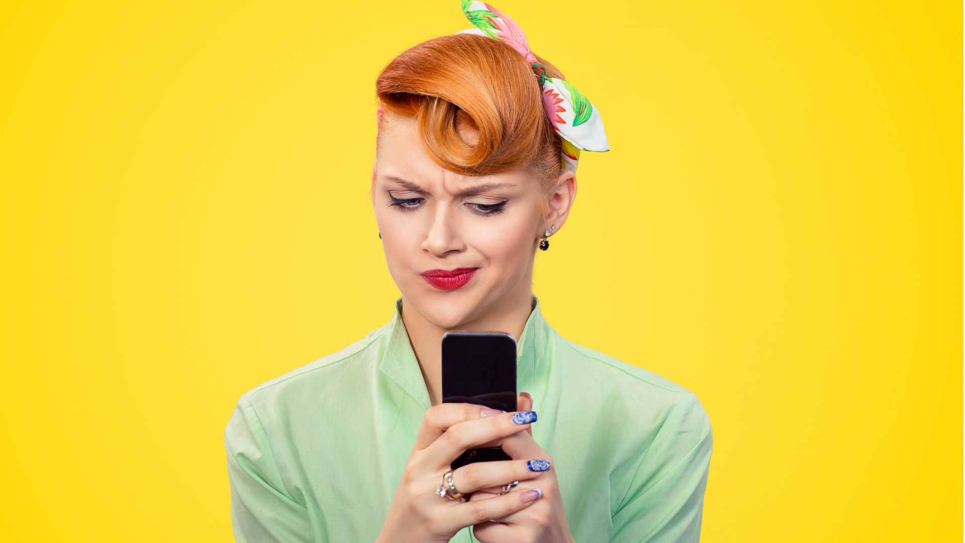 unhappy-serious-woman-looking-at-texting-on-phone-displeased-with-picture-id1035150660