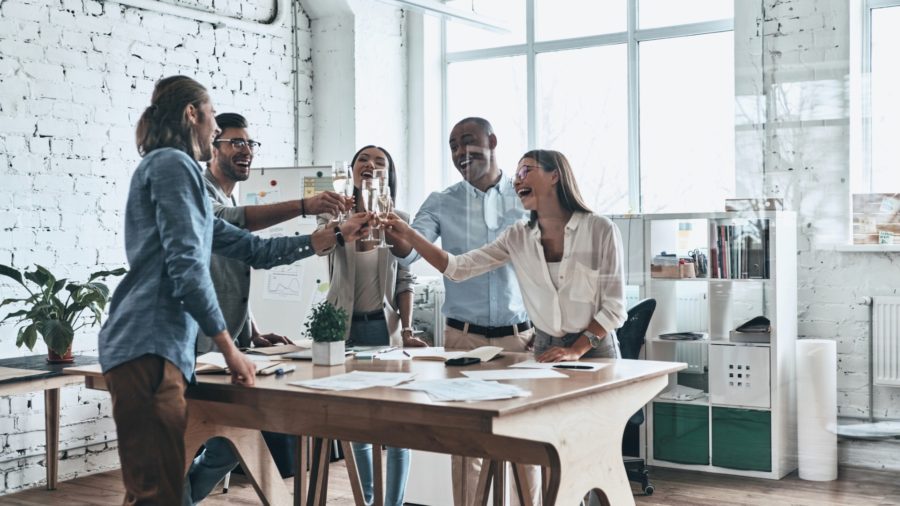 coworkers celebrating their business anniversary with drinks